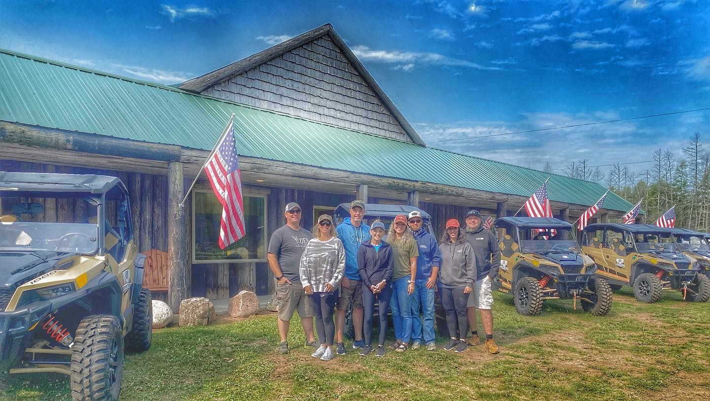a group of people standing in front of a truck