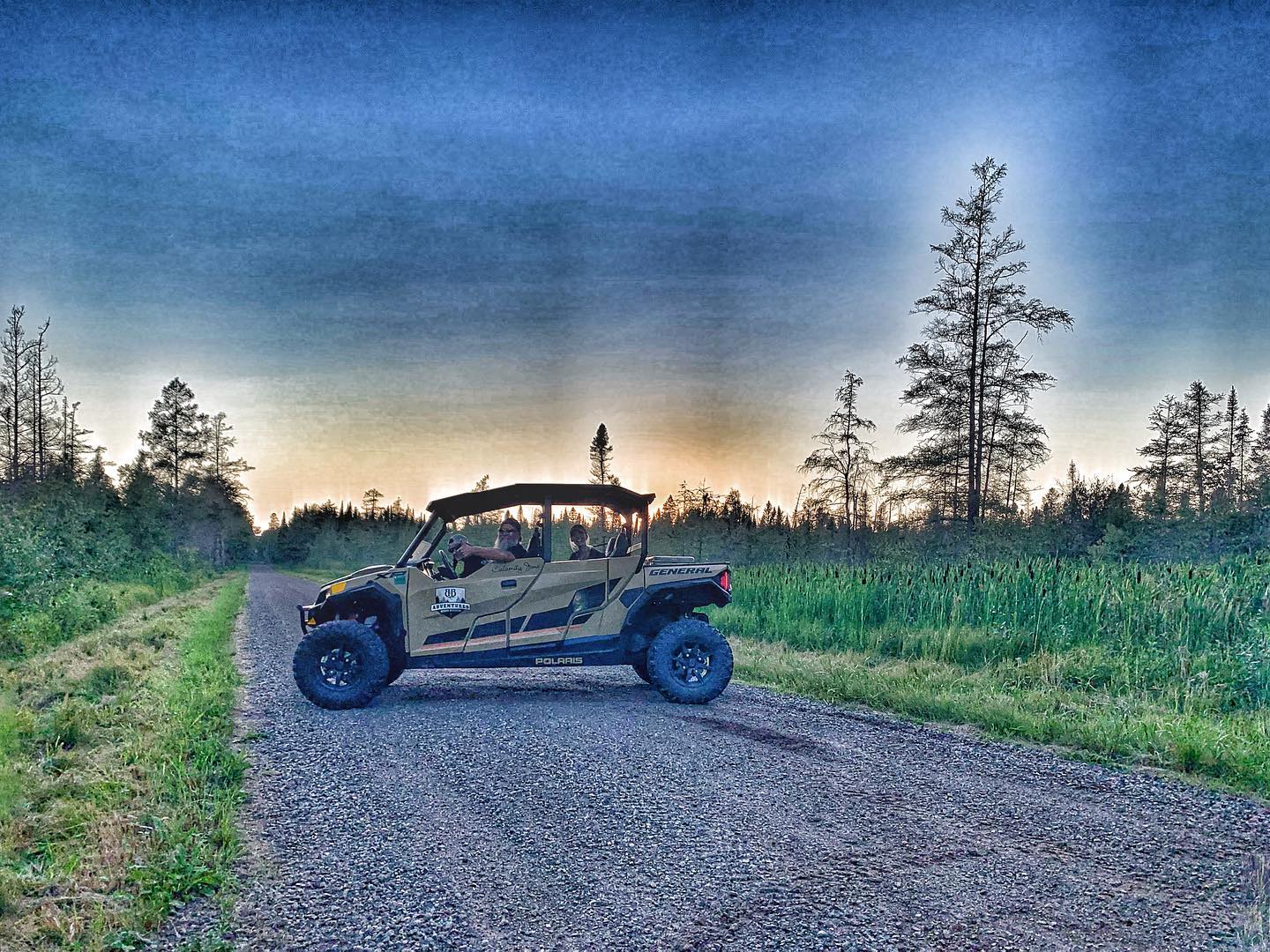 a motorcycle is parked on the side of a dirt road