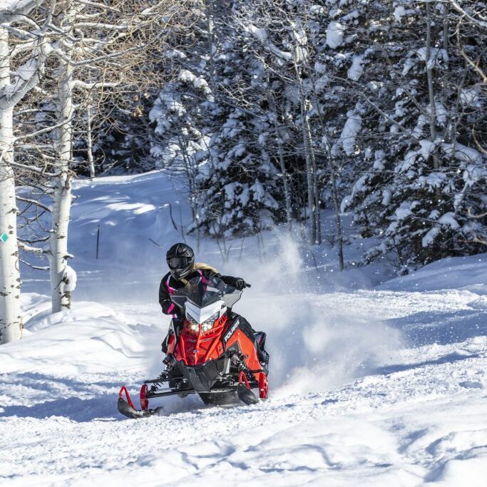 a man riding skis down a snow covered slope