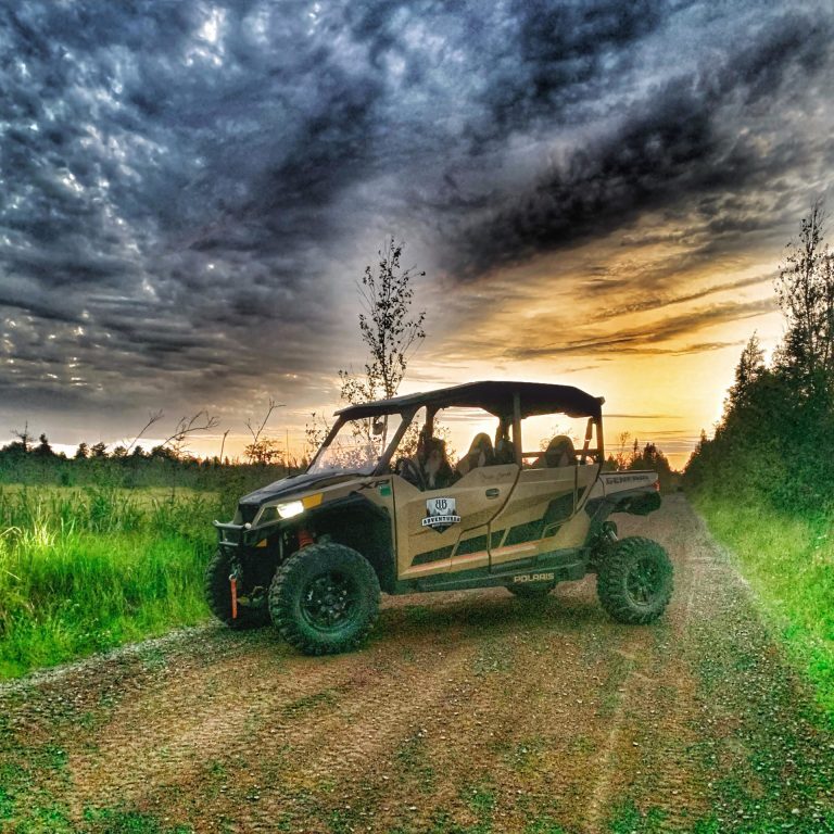 a truck driving down a dirt road