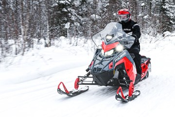 a man riding skis down a snow covered slope